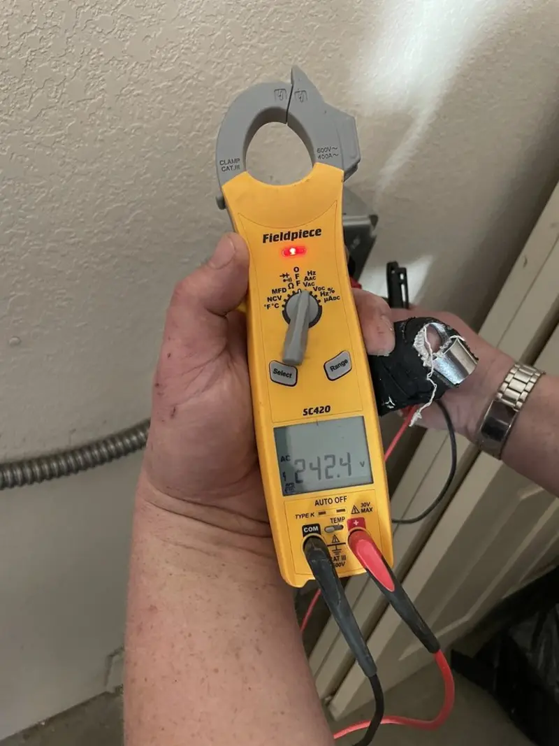 Voltage testing with clamp meter during Electrical Installation Services in Brandon